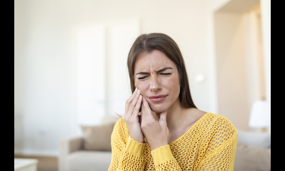 A woman suffering from wisdom teeth extraction pain.