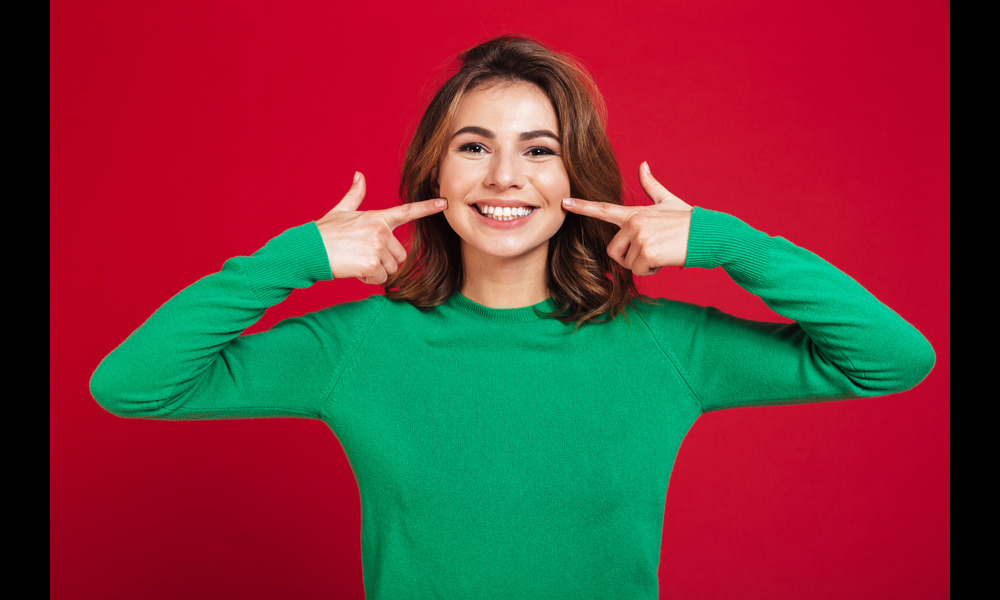 A woman smiling confidently after teeth whitening