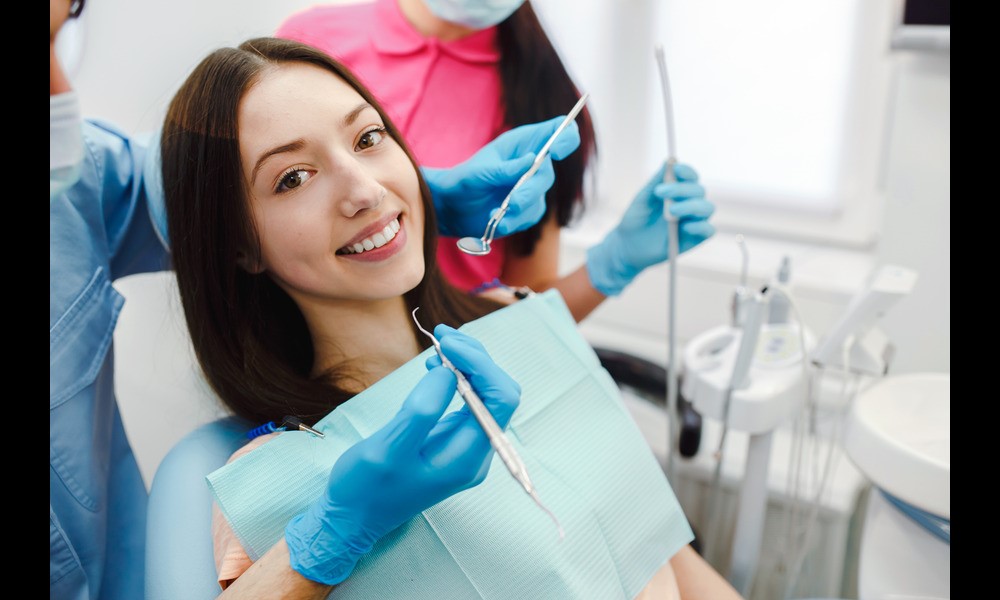 A woman smiling confidently after cosmetic dentistry treatment.