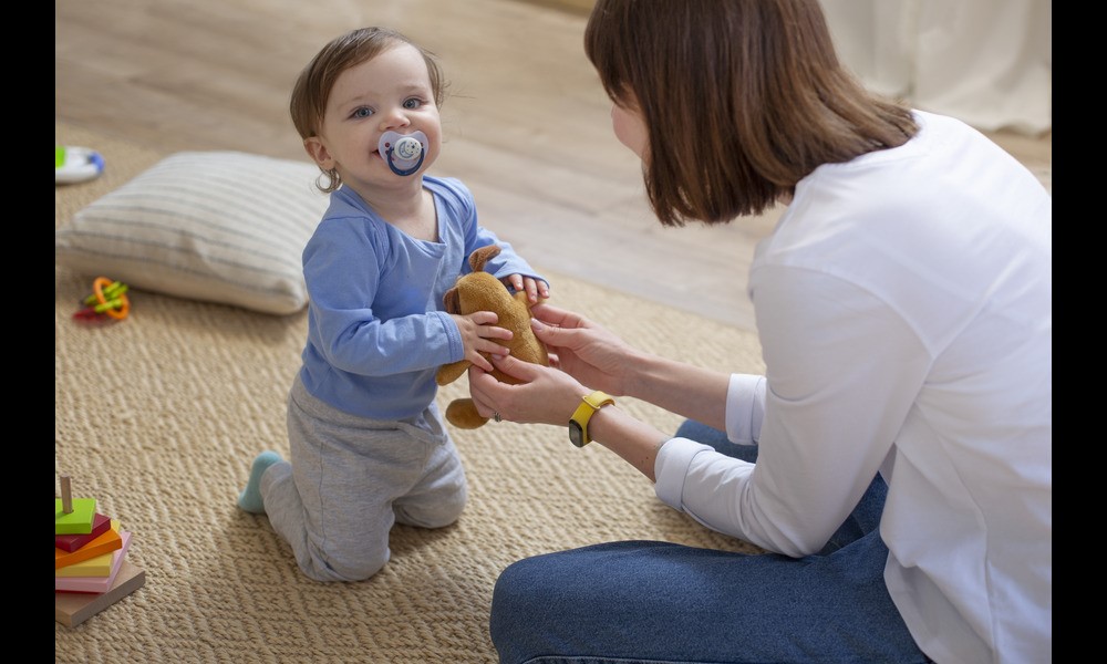 Toddler sucking a pacifier, affecting dental care for children.