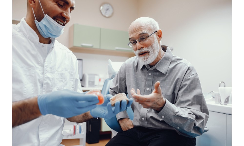 An old man at dental clinic for broken dentures repair