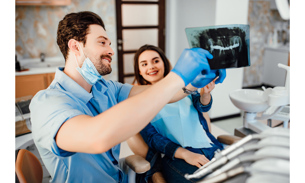 Dentist near me showing patient her dental X-ray